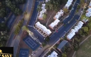 Aerial view of a freshly paved commercial area with clear parking lines and a basketball court, completed by Pave N Save.