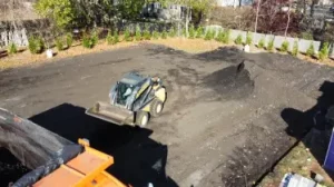 Construction vehicle leveling a worksite.